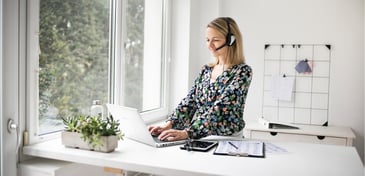 female working on ergonomic home set up with good posture 