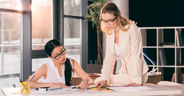 two woman designing a back to work or return to work program after a workplace injury . they are injury management consultant and are providing rtw services.