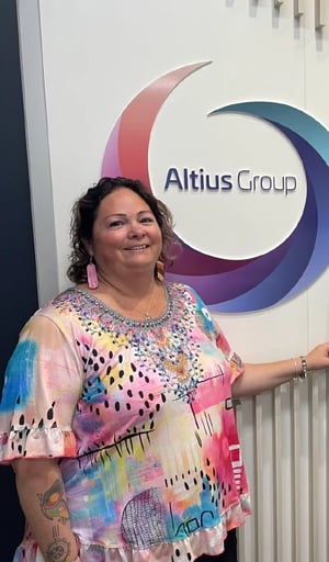 Altius Group Bec leans on sign